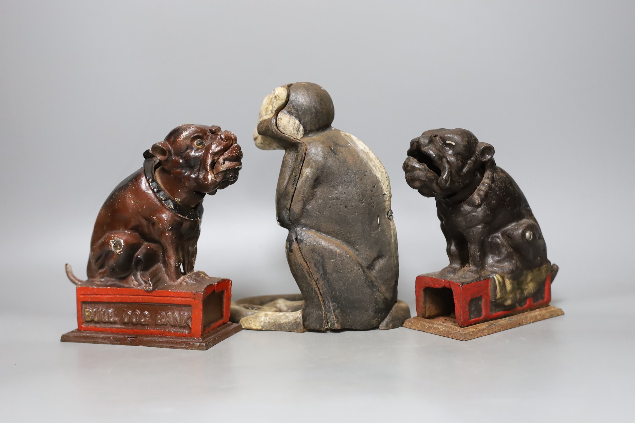 Two cast iron Bull Dog Banks, 16cm, and a cast iron monkey bank